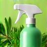Recycled spray bottle and green plant