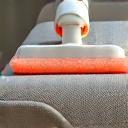 Upholstery tools cleaning a sofa